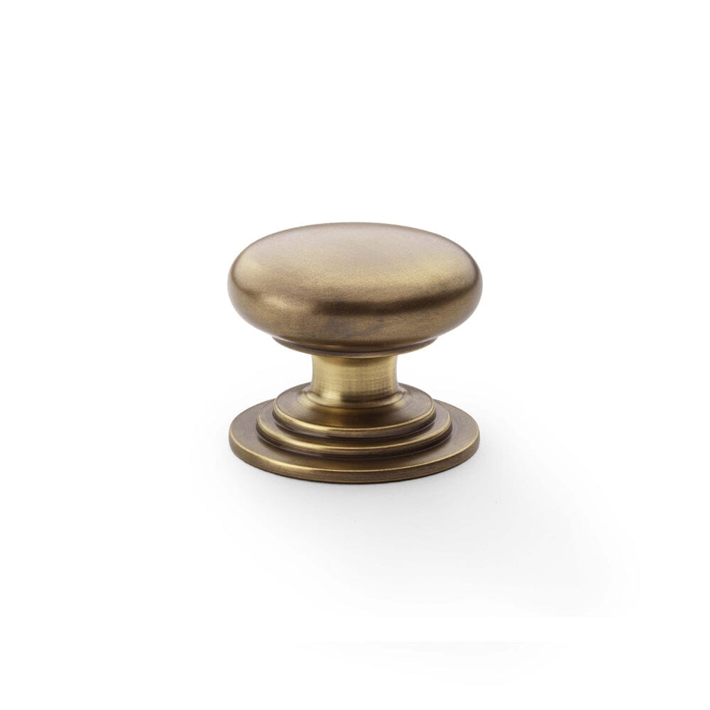 Waltz Round Cupboard Knob on Stepped Rose 38mm Cupboard Knob Alexander & Wilks Antique Brass 